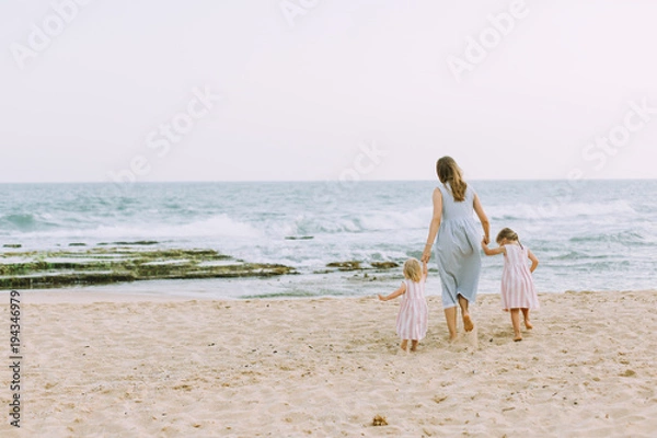 Obraz Young mother with two daughters on the beach