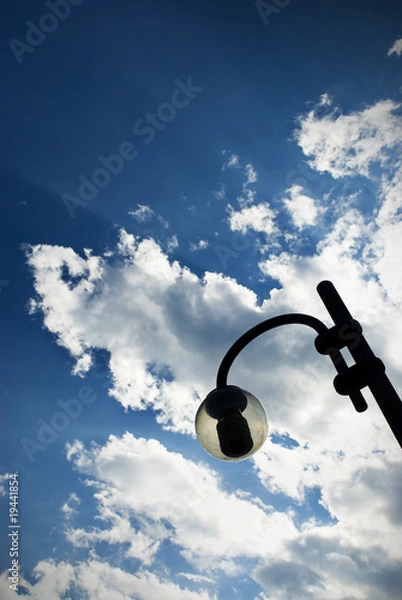 Fototapeta Lamppost with cloudscape background