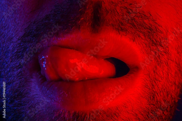 Obraz Macro close up on man with seductive facial expression sticking out his tongue licking his lips
