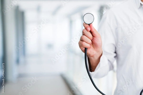 Fototapeta Doctor with stethoscope in hand