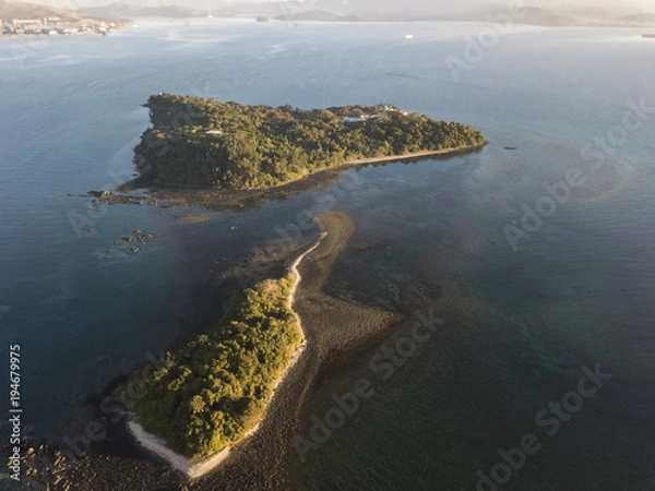 Fototapeta Drone view of 2 small islands cover with trees