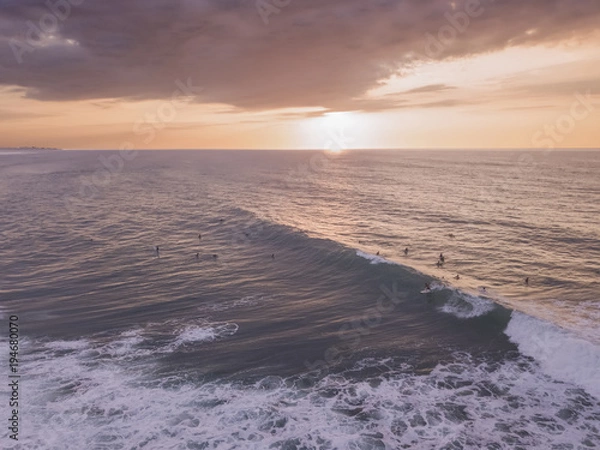 Fototapeta drone view of a surfer in the sunset