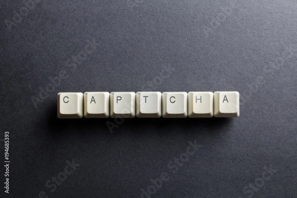 Fototapeta Word captcha made using computer keyboard buttons on a black background. Compact disk. IT technology concept.