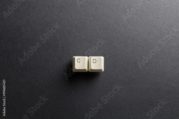 Obraz Word CD made using computer keyboard buttons on a black background. Compact disk. IT technology concept.