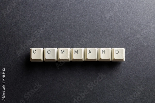 Obraz Word command made using computer keyboard buttons on a black background. IT technology concept.
