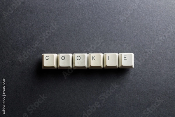 Obraz Word cookie made using computer keyboard buttons on a black background. IT technology concept.