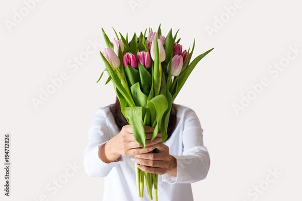 Fototapeta Spring bouquet of pink tulips in woman's hands