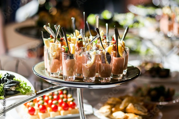 Fototapeta holiday buffet table served by different canape, sandwiches, snacks ready for eating in restaurant