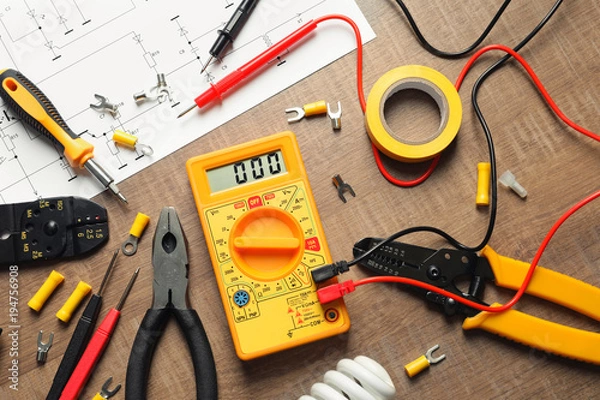 Fototapeta Different electrical tools on wooden background