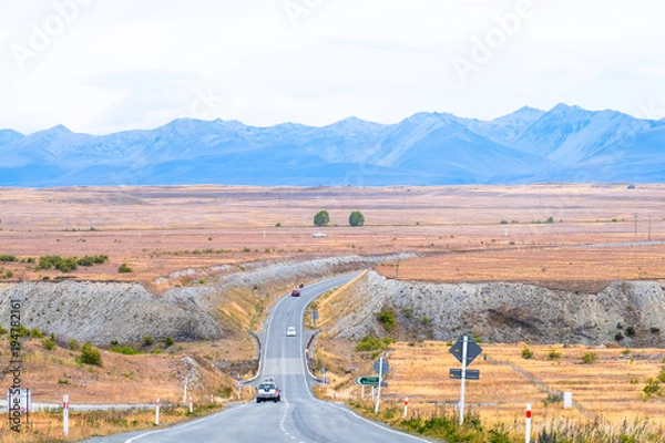 Fototapeta Beautiful scene of mountain, raod, and a field on the way while traveling in South Island, New Zealand