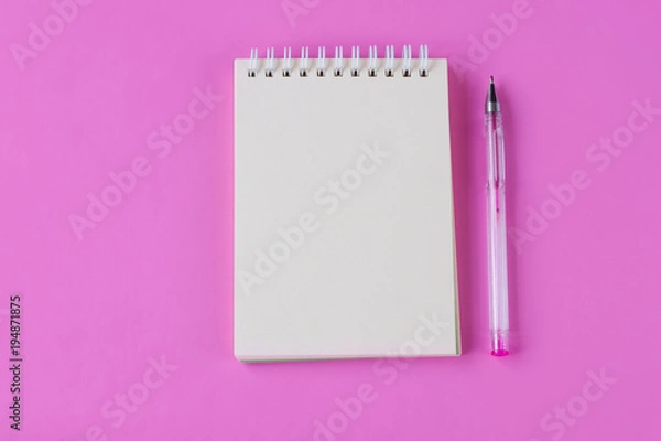 Fototapeta Notebook and pen on pink background. Space for text
