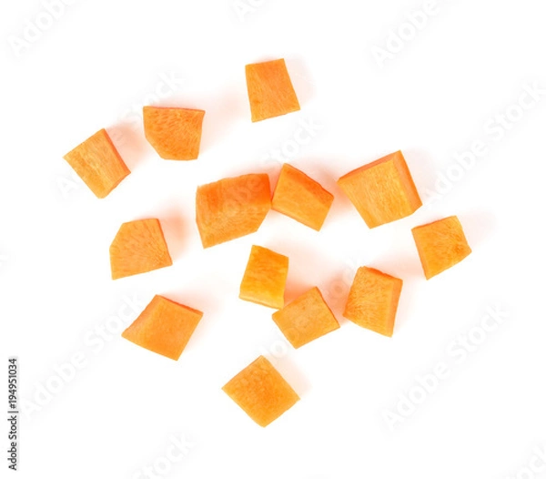 Fototapeta Fresh carrot. Cubes sliced isolated on white