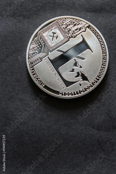Fototapeta The silver litecoin. Altcoin on black table.