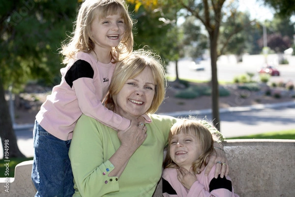 Fototapeta twins hugging grandma