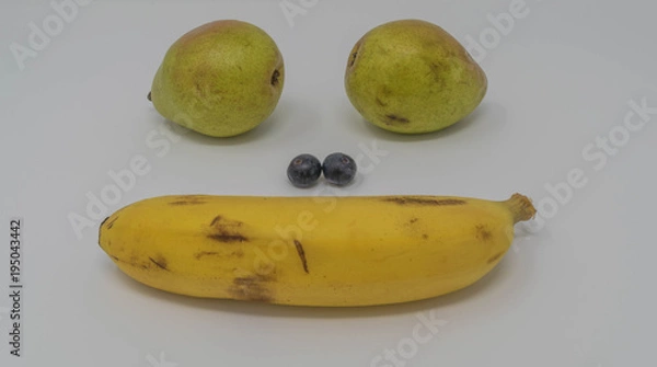 Fototapeta Studio shot of a fruit face, with pears, blueberries and a banana