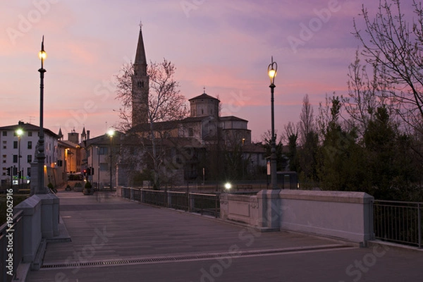 Fototapeta The cathedral of Saint Mark from Adam and Eve Bridge, in Pordenone, at sunset. Italy.