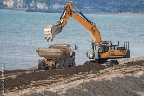 Obraz Construction Site - Engineering - Sea Defence. Large plant machinery being use to build the beach sea defence at Seaford, East Sussex, UK