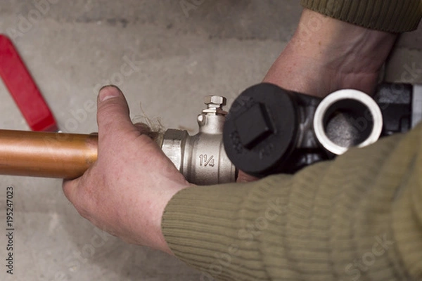 Obraz copper pipes installing screwdriving