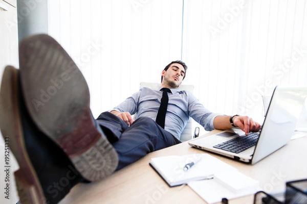 Fototapeta Lazy businessman put his legs on the desk