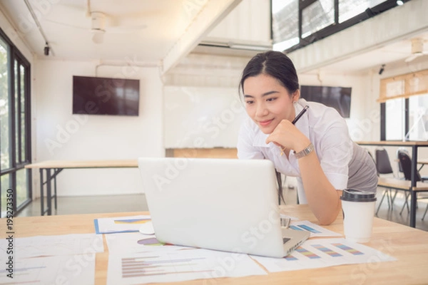 Fototapeta Calculating the cost of postage of a small package, Small business enterprise concerns for online Shopping