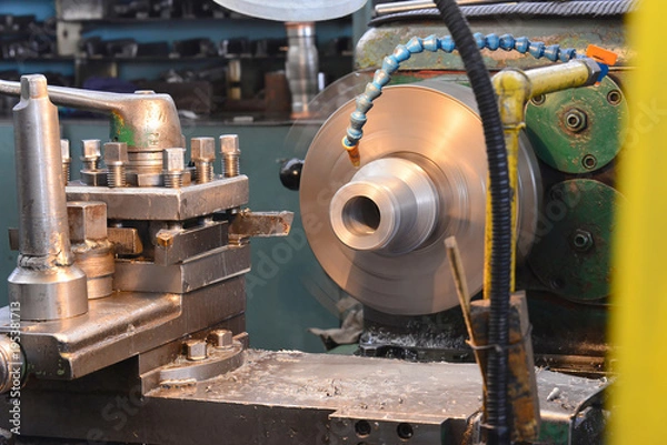Fototapeta Machining on a lathe, processing of metal by cutting.