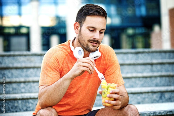 Obraz Man is eating fruit salad
