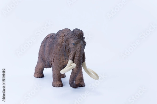 Fototapeta Prehistoric Big tusks Brown Mammoth toy on white background side view