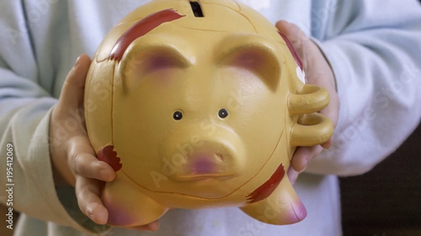 Obraz Financial education concept - saving money from a small one child, piggybank in a small hands