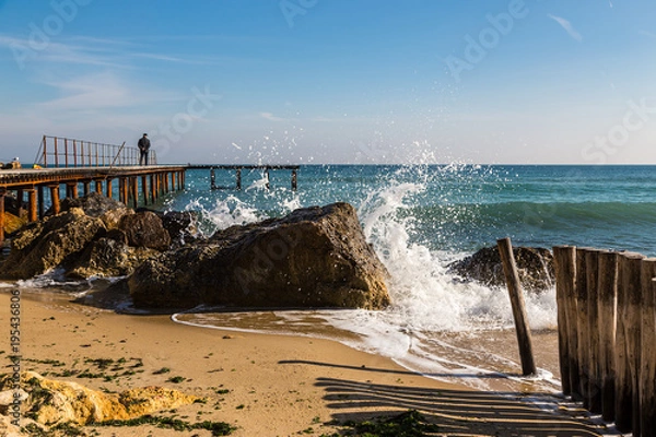 Obraz A man on an empty pier.