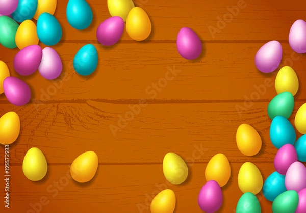 Fototapeta Easter frame with shiny colorful happy eggs spread over wooden background