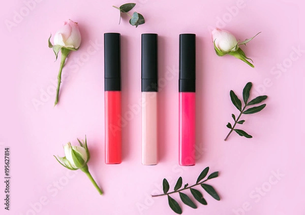 Obraz Lip gloss with flowers on a pink background