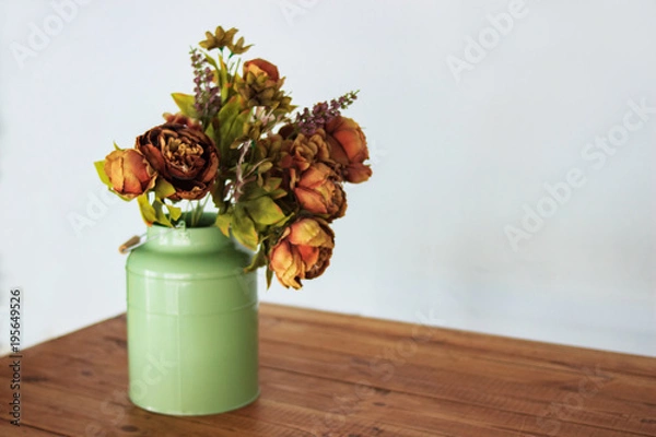Fototapeta Bouquet of dried flowers in vase on table and light background. A bouquet of dried flowers in a vase. Dry flowers