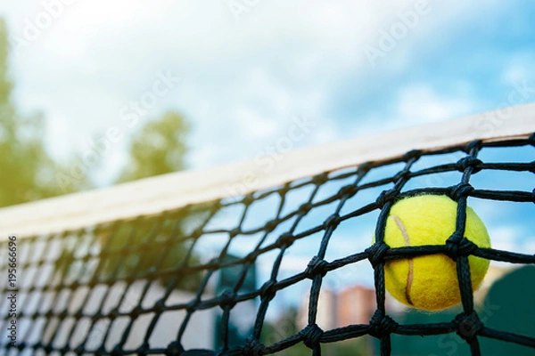 Fototapeta Close-up photo of tennis ball hitting to net. Sport concept.