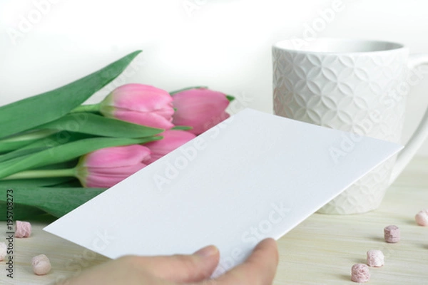 Fototapeta Woman's hand with postcard