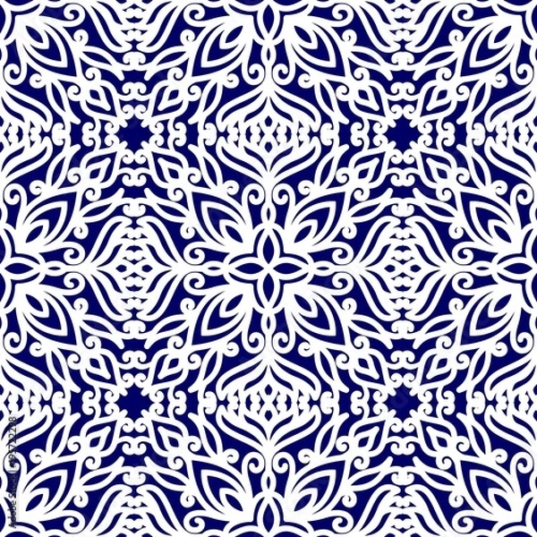 Fototapeta Seamless pattern with ethnic ornaments with curls. White floral pattern on a blue background.