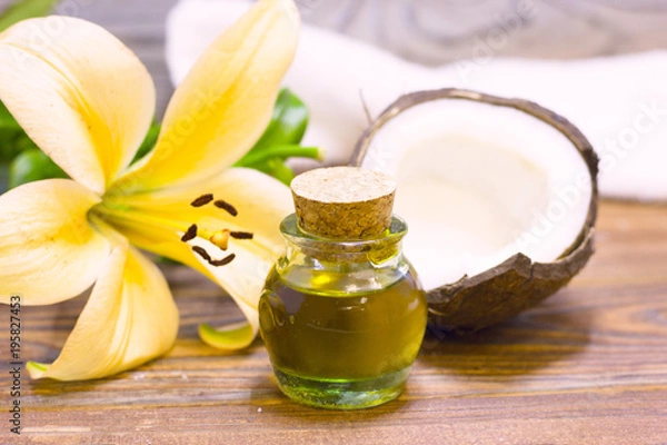 Obraz Natural herbal skin care products, top view ingredients coconut, lily flower, essence oil on table concept of the best all natural face moisturizer. Facial treatment preparation background