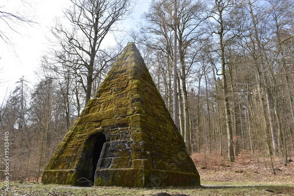 Fototapeta Ancient stone pyramid with moss in the forest on the way to the World Cultural Heritage Herkules in Kassel, Wilhelmshöhe, Germany