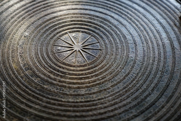 Obraz Surface of ancient magnificent bronze drum, Frog drum or Rain drum in Thailand. Circular line texture background