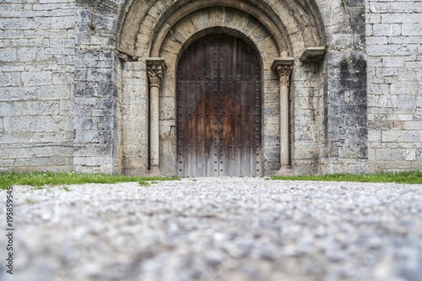 Fototapeta Architecture element, ancient door, religious building, Monastery, Monestir Sant Pere, romanesque style, Camprodon, ripolles comarca region, province girona, Catalonia.Spain.
