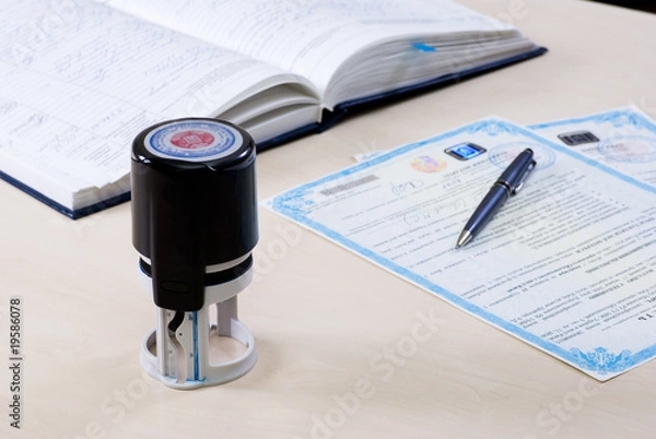 Obraz stamp and notary's book on the table and the document signed by