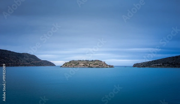Fototapeta View of the island of Spinalonga with calm sea. Here were isolated lepers, humans with the Hansen's desease, gulf of Elounda, Crete, Greece. 