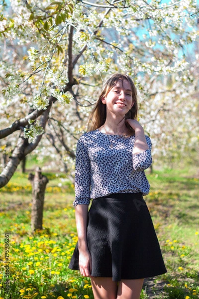 Obraz girl in a blooming spring garden