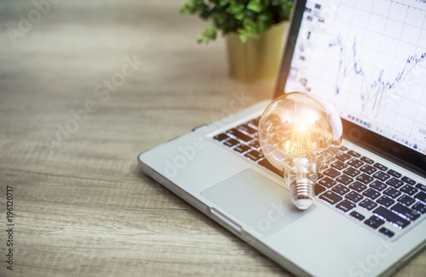 Fototapeta Light bulb on notebook notebook