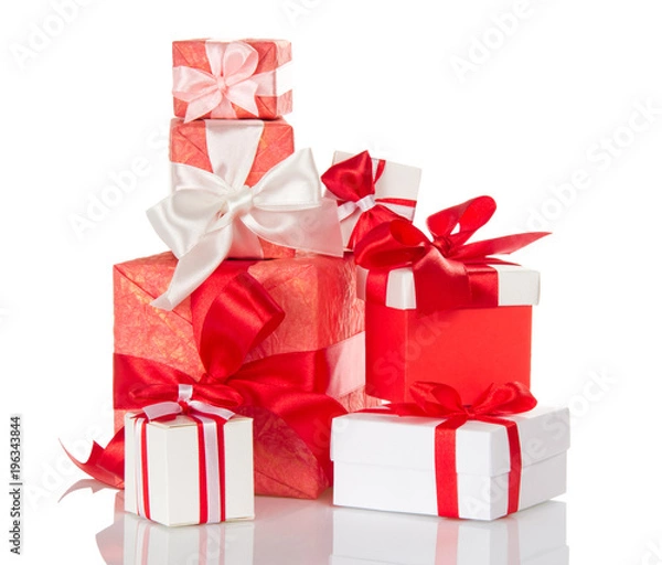 Fototapeta Heap of bright gift boxes decorated with red and white bows isolated on white