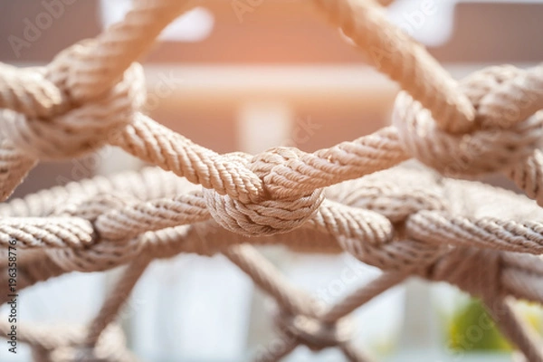 Fototapeta Close-up of rope knot line tied together with playground background.selective focus.