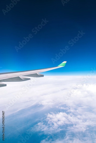 Fototapeta Looking through window aircraft during flight in wing with a nice blue sky