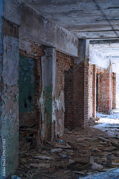 Fototapeta Inside an old abandoned building. The interior of the collapsing building