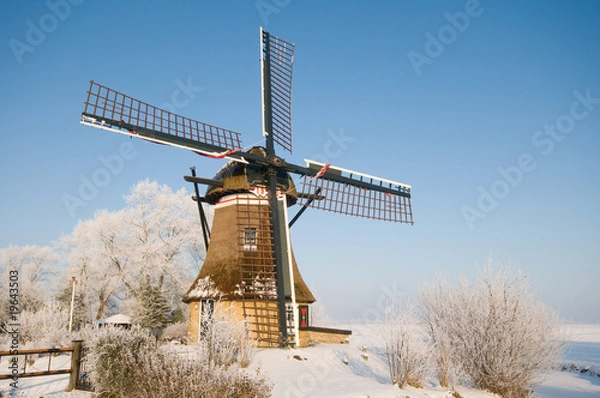 Obraz A mill in a winter landscape