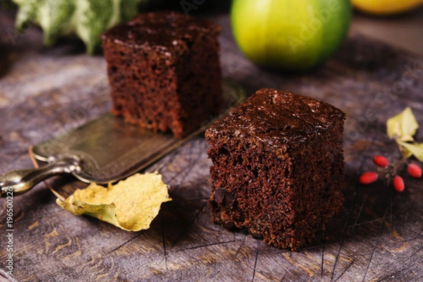 Fototapeta Chocolate zucchini brownie on a vintage wooden table. Proper nutrition. Healthy dessert. Selective focus
