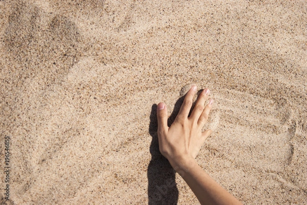 Fototapeta Background with hand on the sand